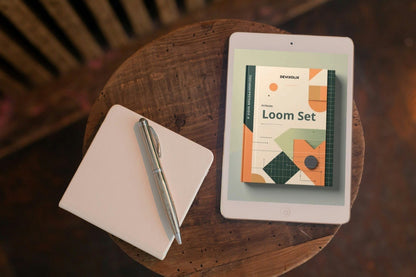 Tablet displaying a product image on a wooden table with a notebook and pen.