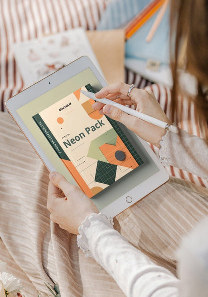 Person holding a tablet with a design app open on a blurred indoor background